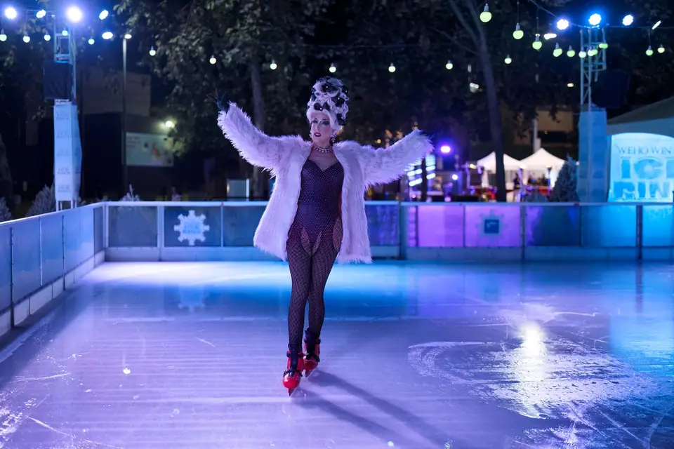 A performer gliding under purple light